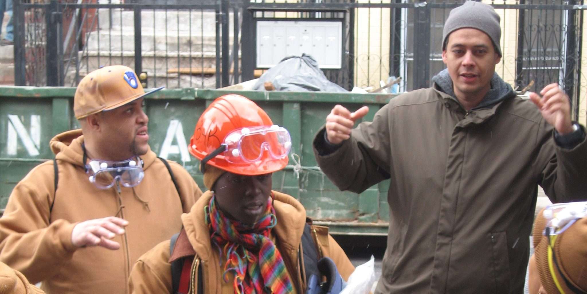Instructor Ramon Casado teaching building science techniques to trainees at a Bronx worksite