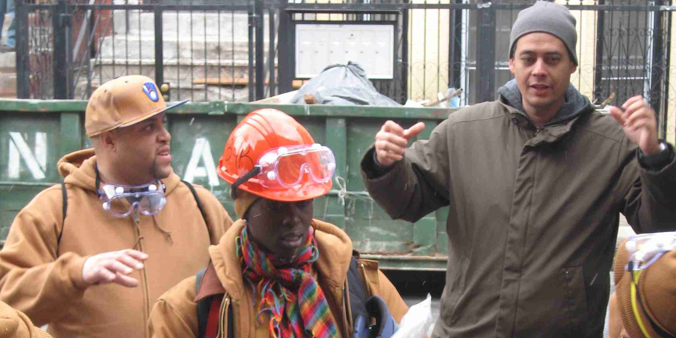 Instructor Ramon Casado teaching building science techniques to trainees at a Bronx worksite