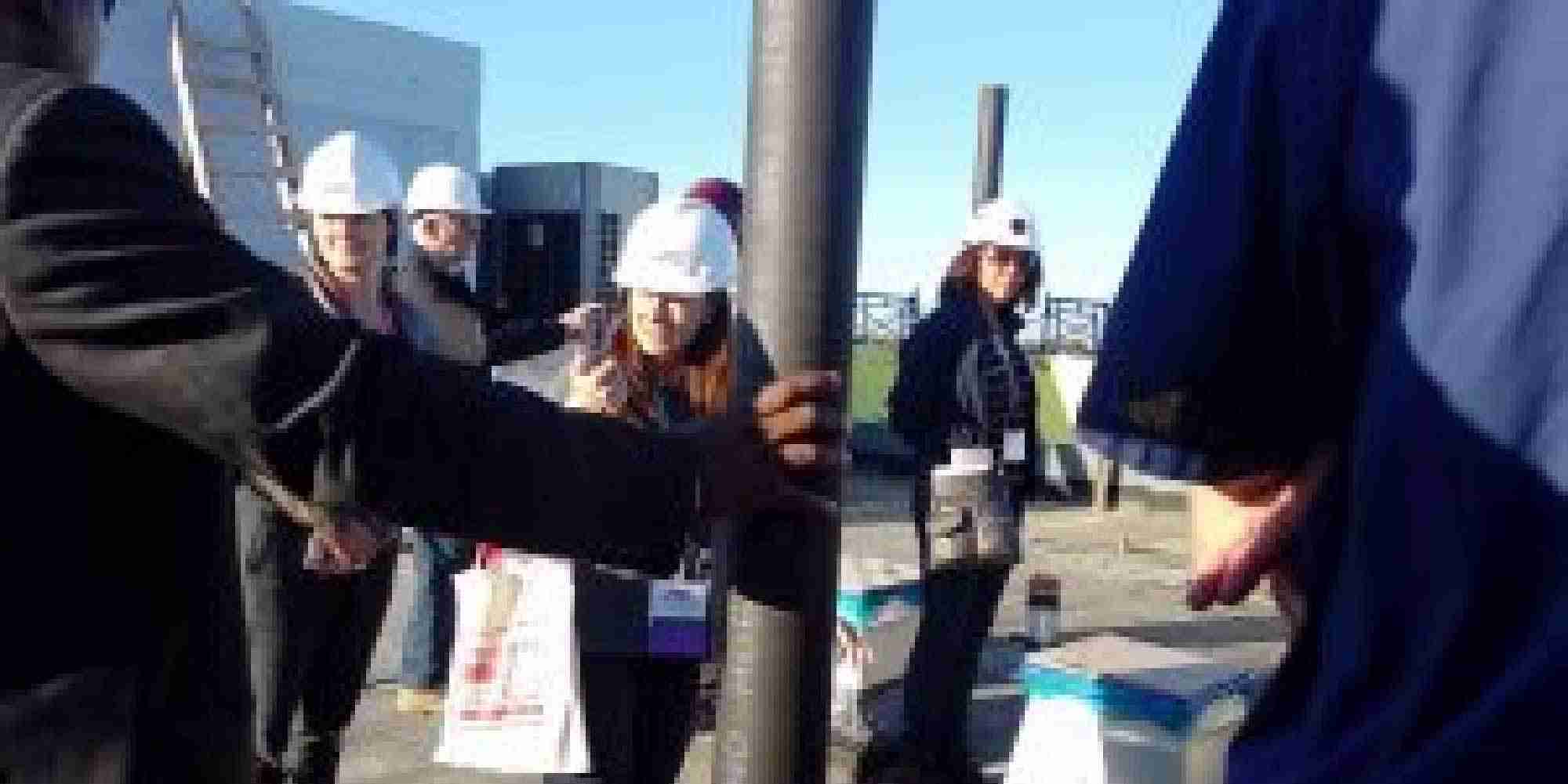 Participants wearing hard hats during the HANAC Corona Passive House ProTour at a construction site in Queens, New York