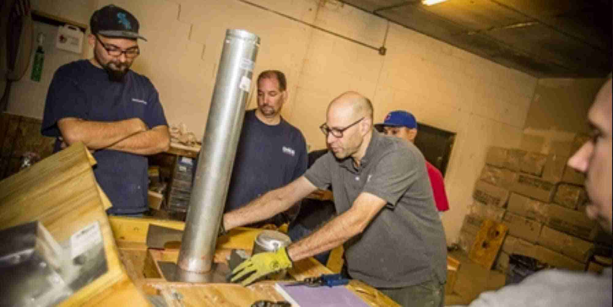 Steve Marchese teaching air sealing techniques with training mockups built by Nate Price at AEA’s Chicago lab