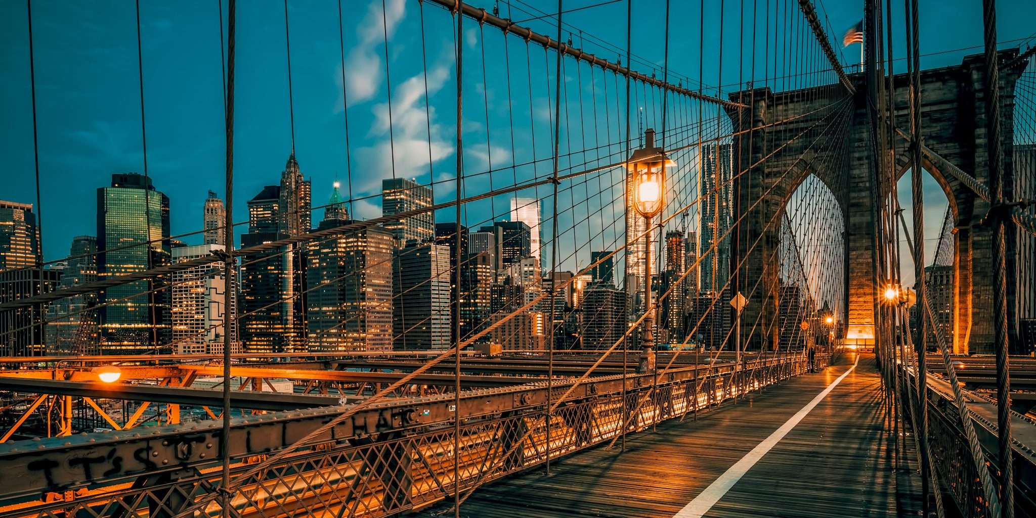 Brooklyn Bridge at night with New York City skyline in the background